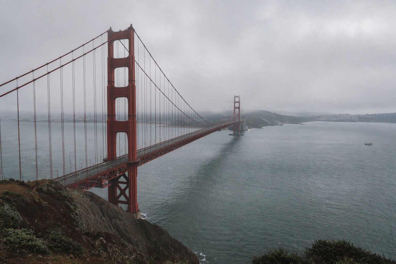 Golden Gate Bridge in fog over San Francisco Bay